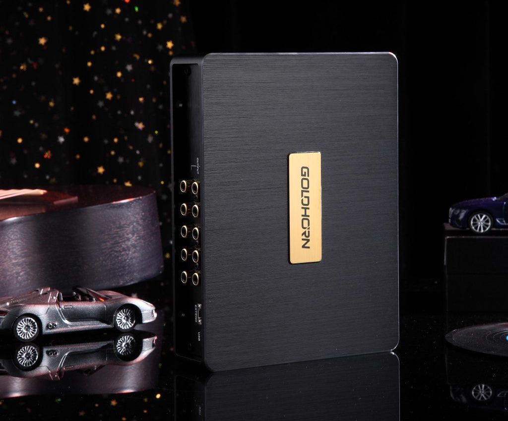 Black electronic device with gold logo on a reflective surface, starry background