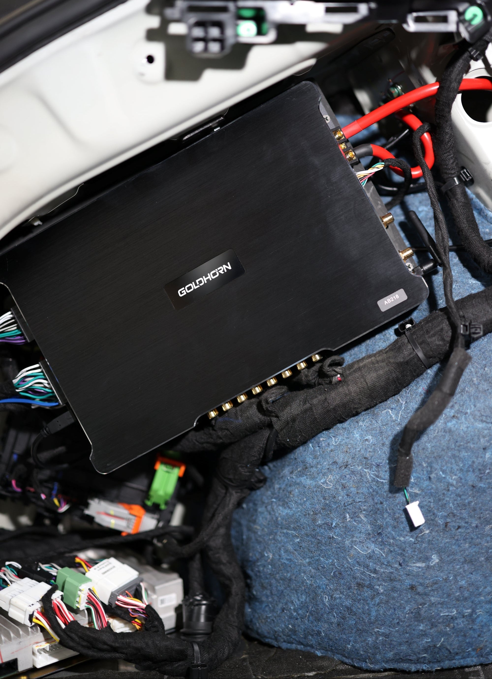 Car audio amplifier installed in a vehicle's dashboard.